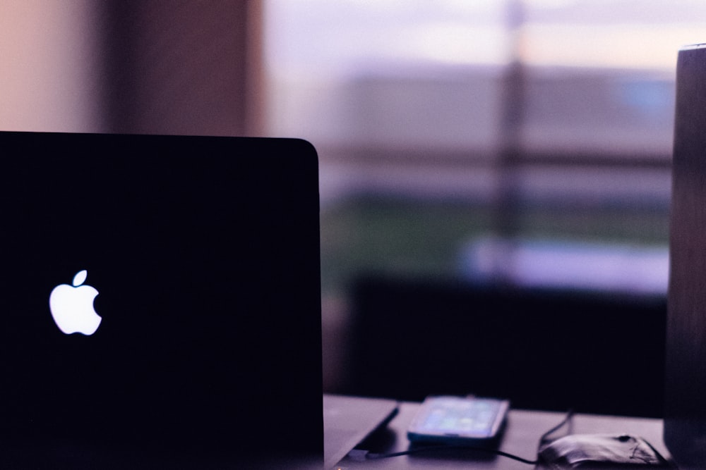 a laptop computer sitting on top of a wooden desk