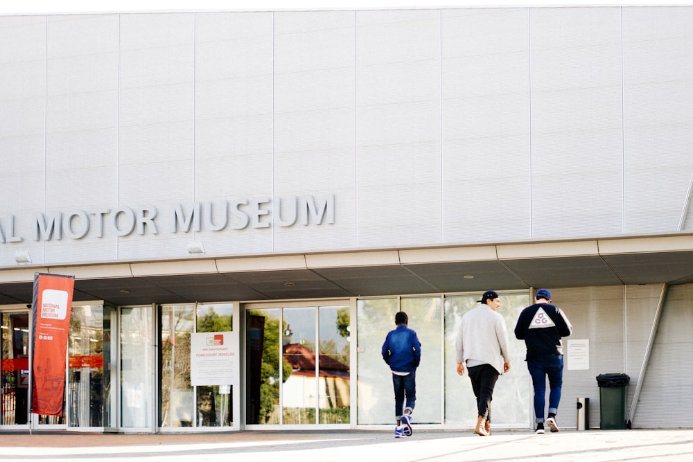 two people walking in front of a museum