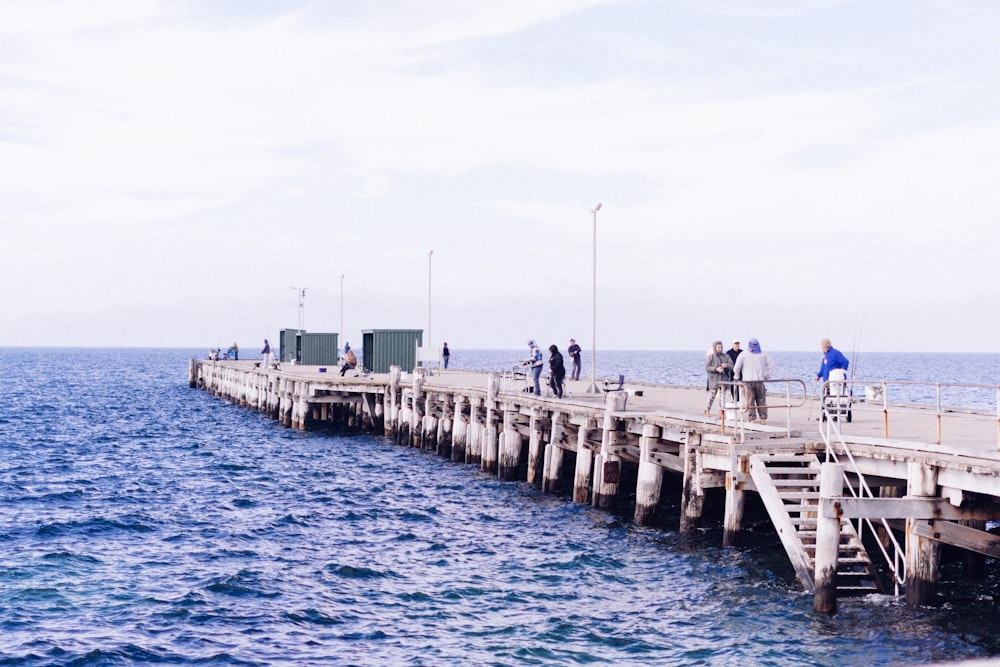 a group of people riding bikes on top of a pier