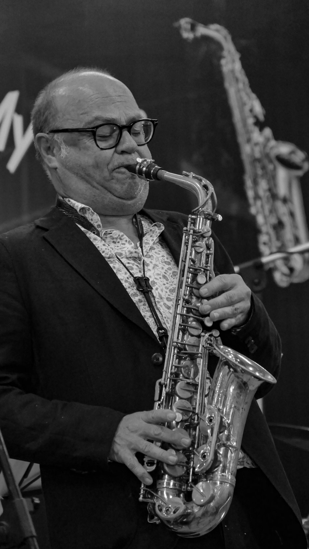 a man in a suit playing a saxophone