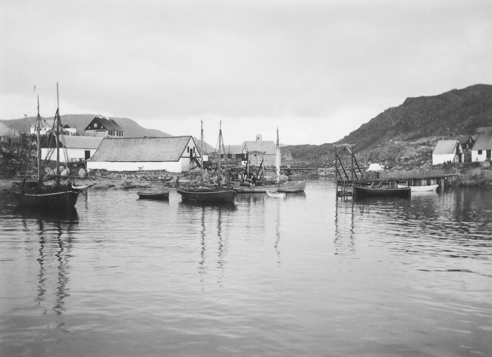 a black and white photo of boats in a harbor