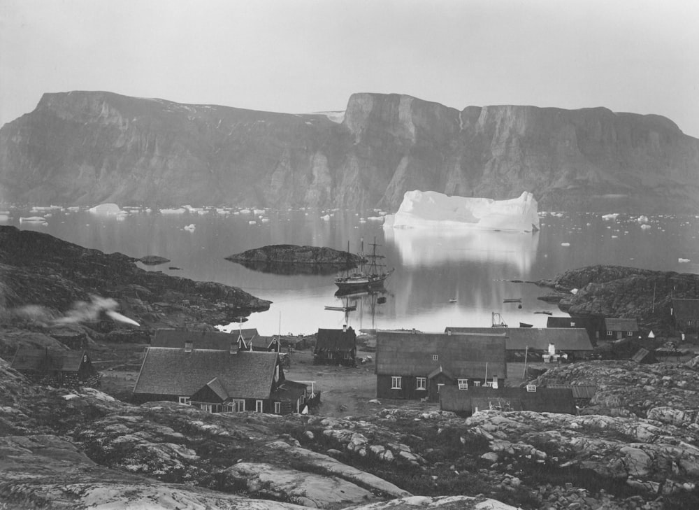 a black and white photo of an iceberg in the water