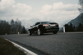 A sleek Swiss car on a scenic mountain road, representing the journey ahead.