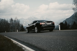 A sleek Swiss car on a scenic mountain road, representing the journey ahead.