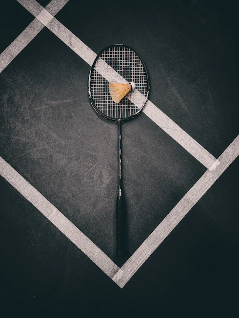 a tennis racket with a piece of cheese on it