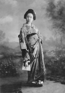 an old photo of a woman in a kimono