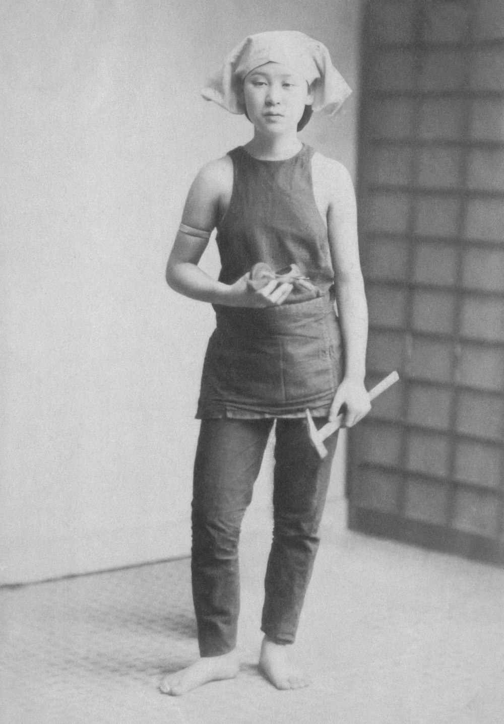 an old photo of a woman holding a baseball bat