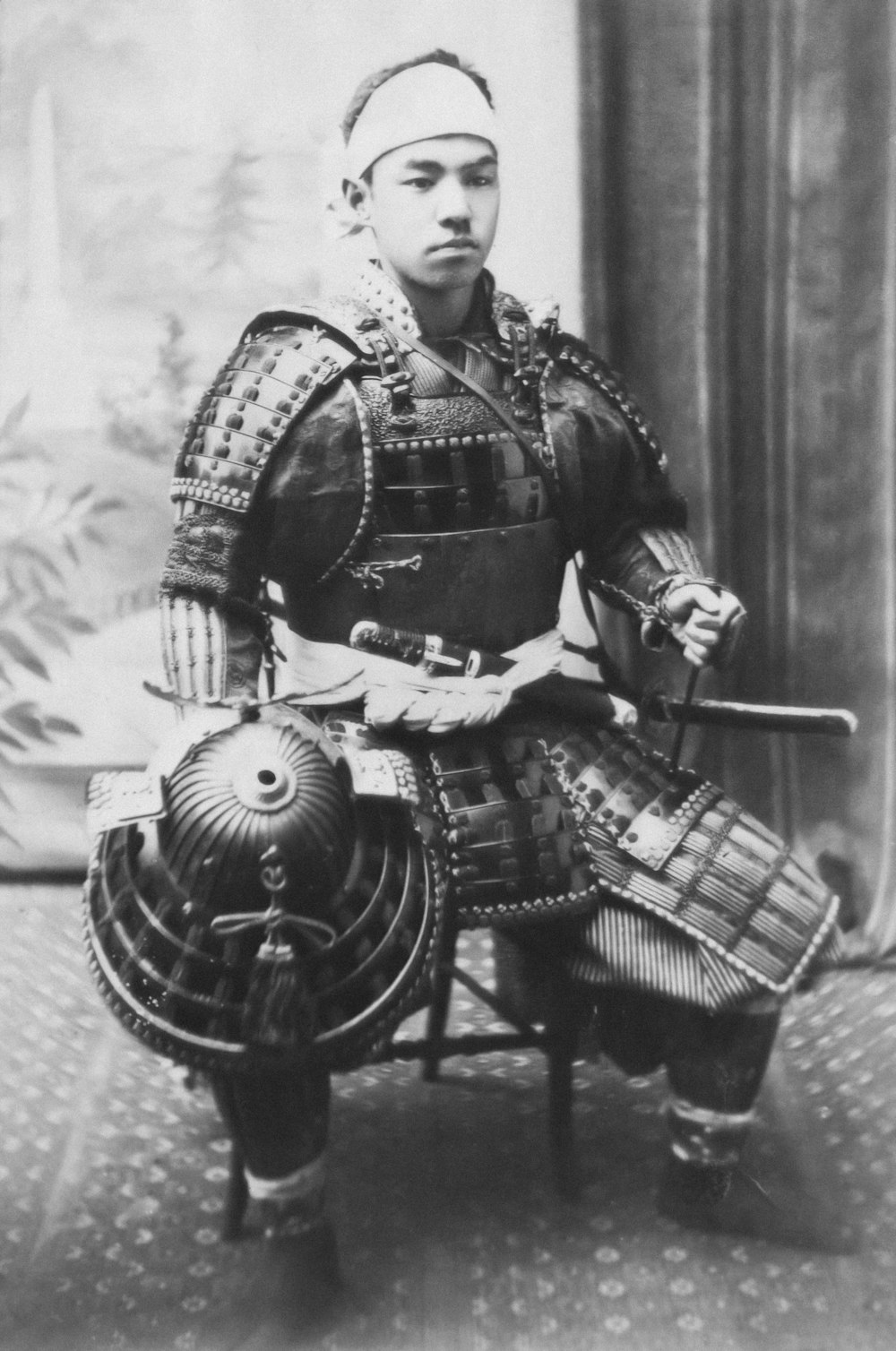 a black and white photo of a man in armor