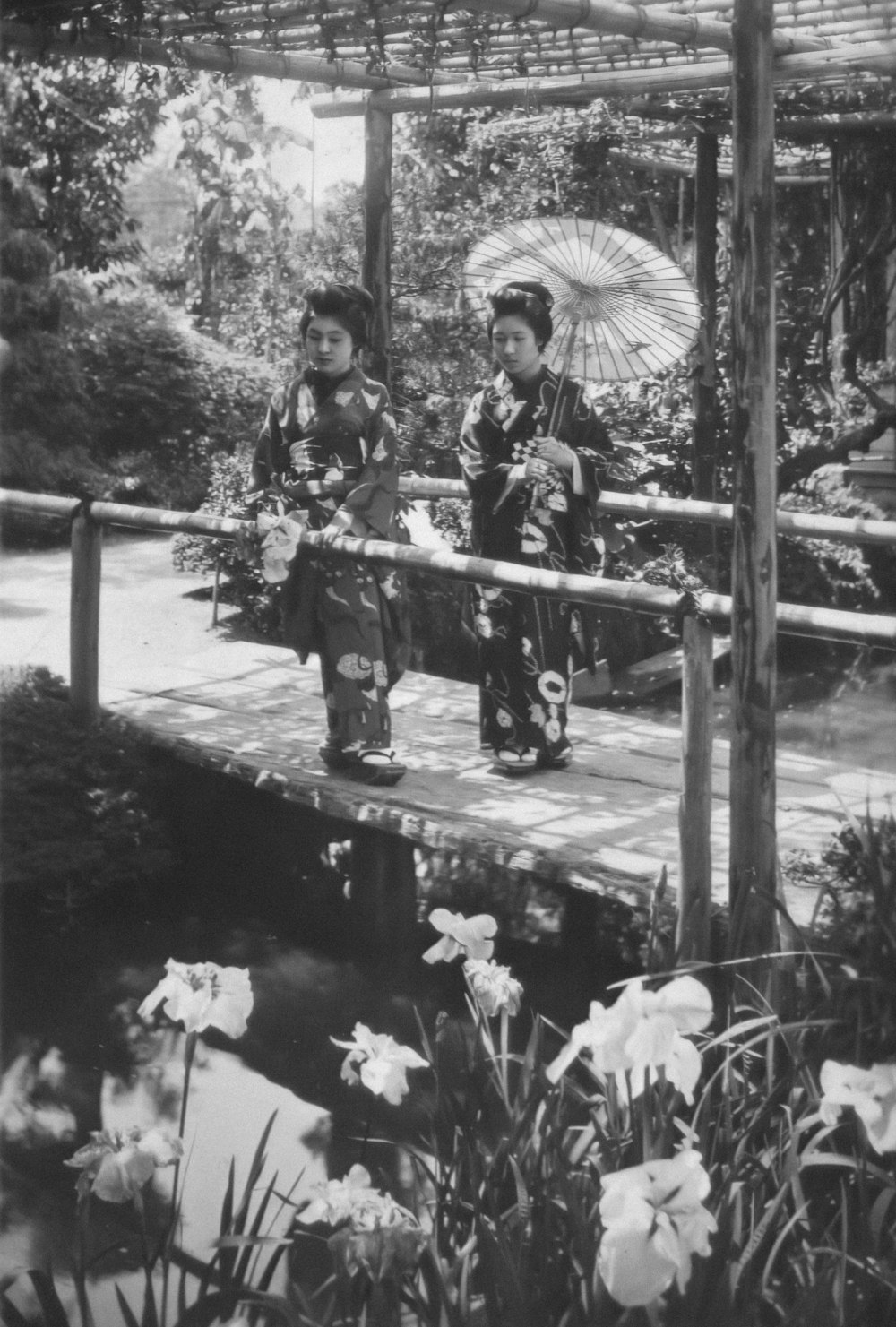 a couple of people that are standing on a bridge