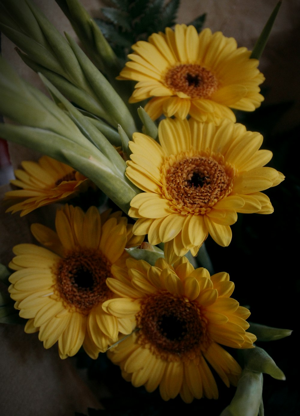 a bunch of yellow flowers sitting on top of a table