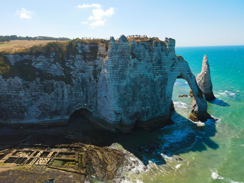 an aerial view of a rock formation in the ocean