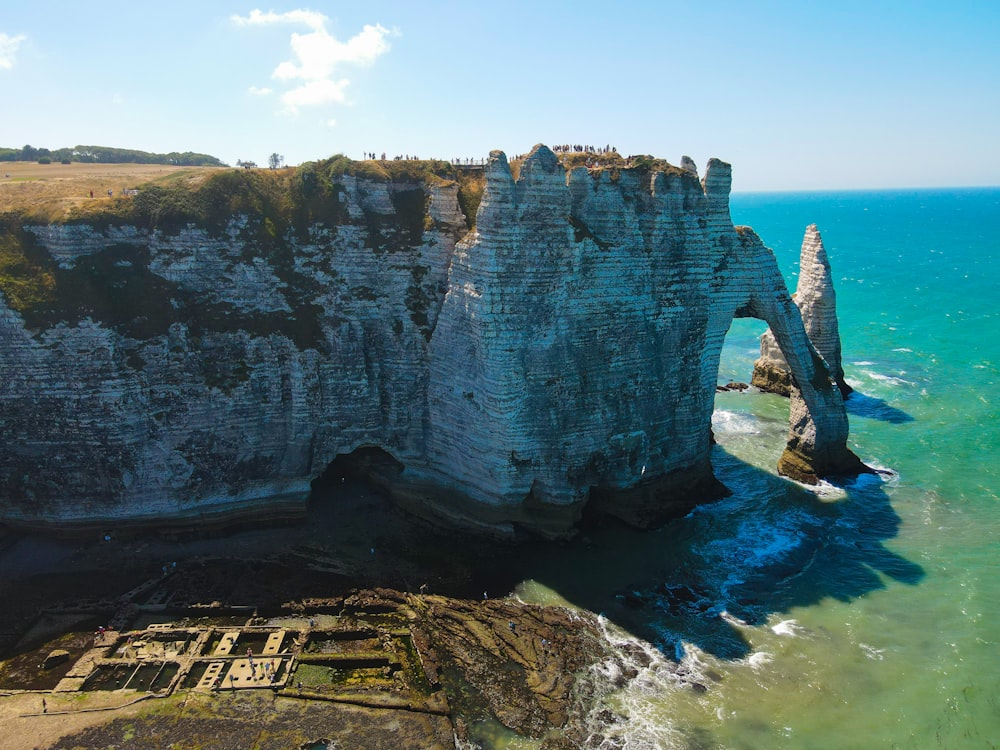 an aerial view of a rock formation in the ocean