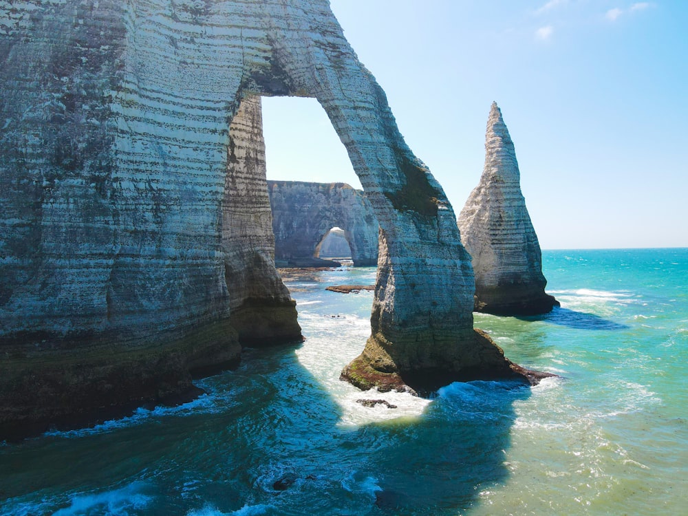 a large rock formation in the middle of the ocean