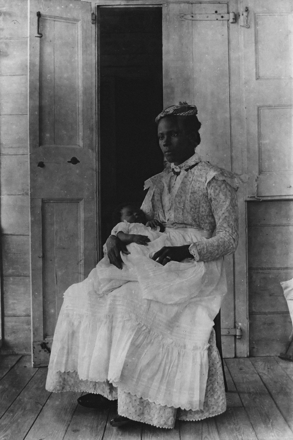 an old photo of a woman holding a baby