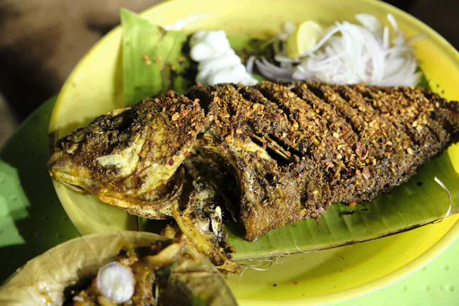 Close-up of a traditional Banten spicy grilled fish served on a banana leaf