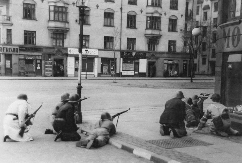 a group of people sitting on the side of a road