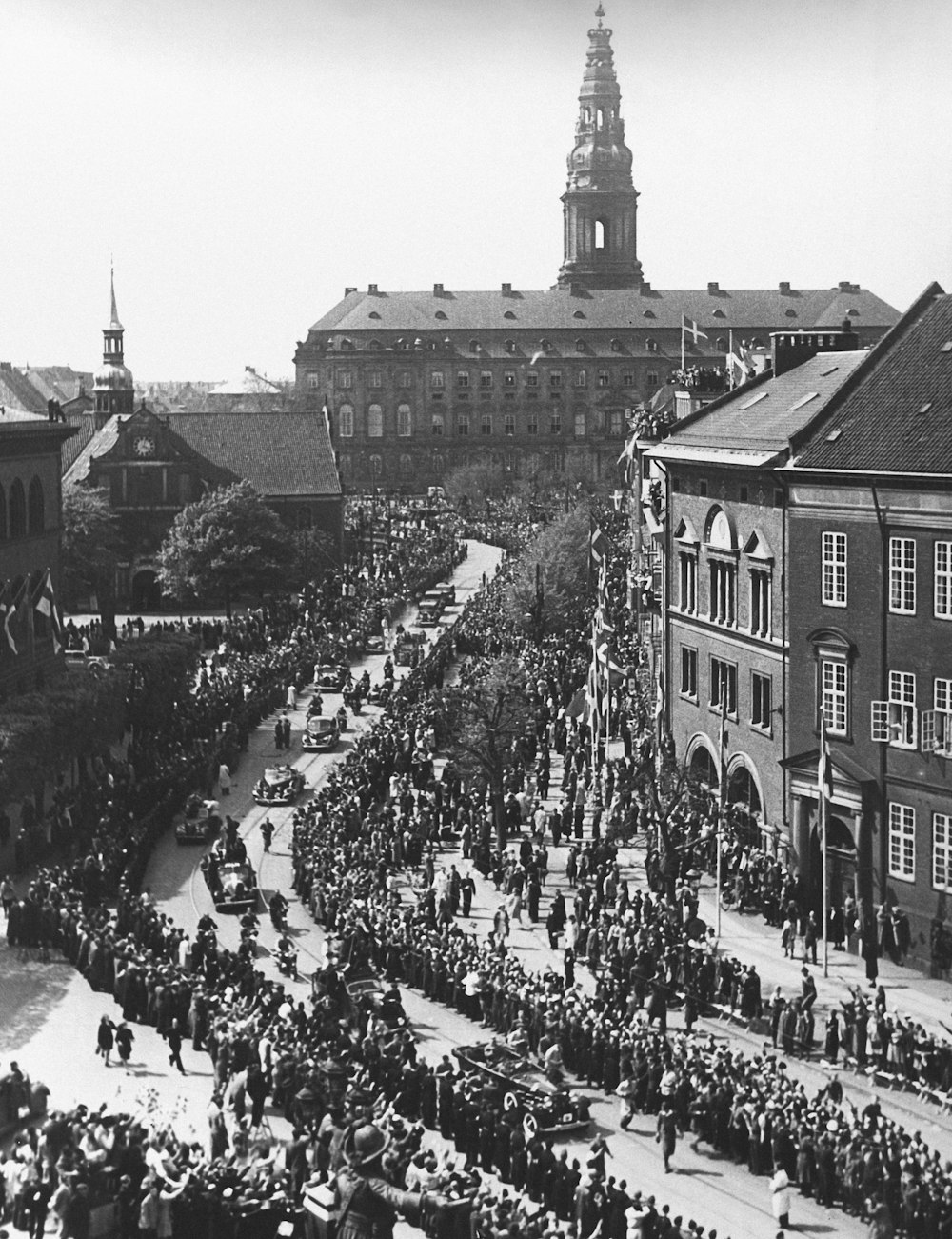 a crowd of people standing on top of a street