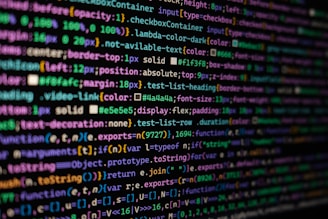 The image features colorful lines of code on a computer screen, showcasing various syntax elements with different colors to highlight keywords, values, and functions. The background is dark, enhancing the visibility of the text.