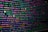 The image features colorful lines of code on a computer screen, showcasing various syntax elements with different colors to highlight keywords, values, and functions. The background is dark, enhancing the visibility of the text.