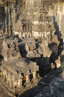 An ancient temple carved into rock, featuring intricate sculptures of Shiva.