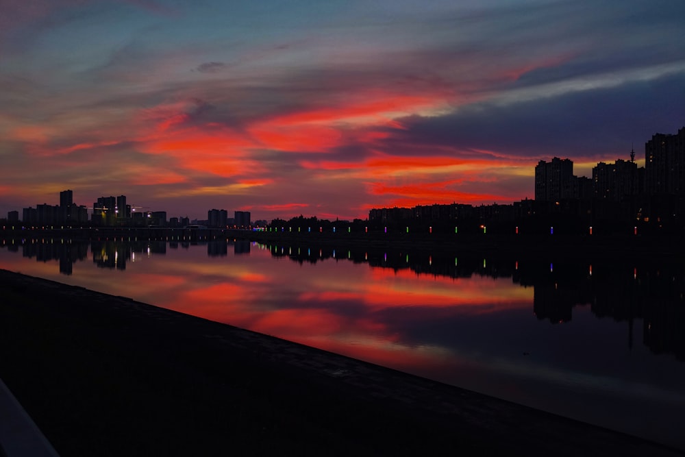 a sunset view of a city and a body of water