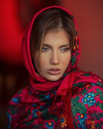 A colorful printed scarf gently wrapped around a woman's neck on a brisk fall day.