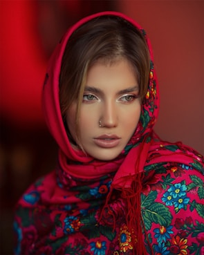 A model wearing a personalized silk scarf with soft pastel colors in natural light.