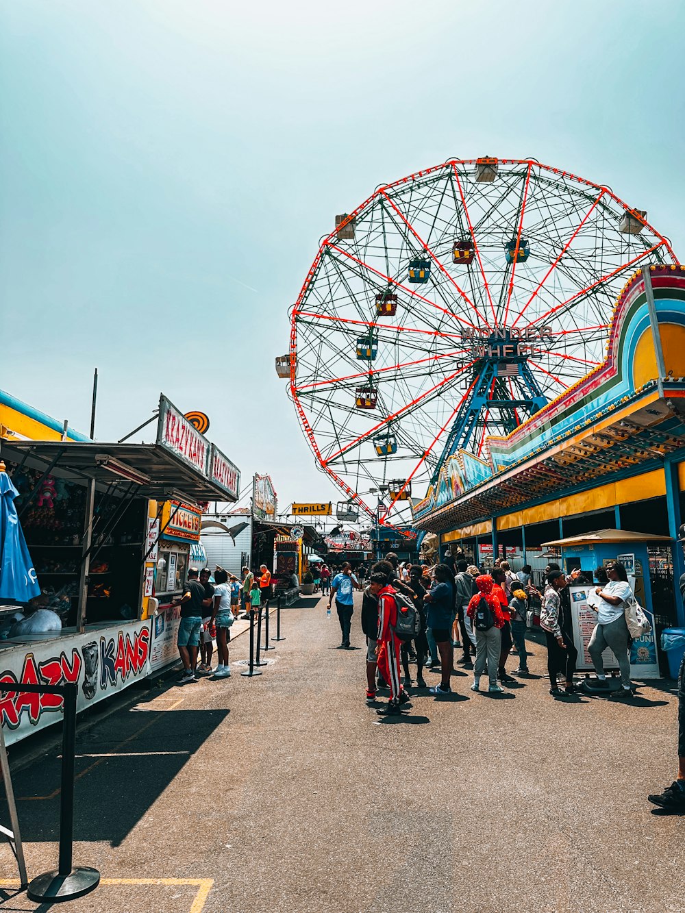 a crowd of people standing around a carnival