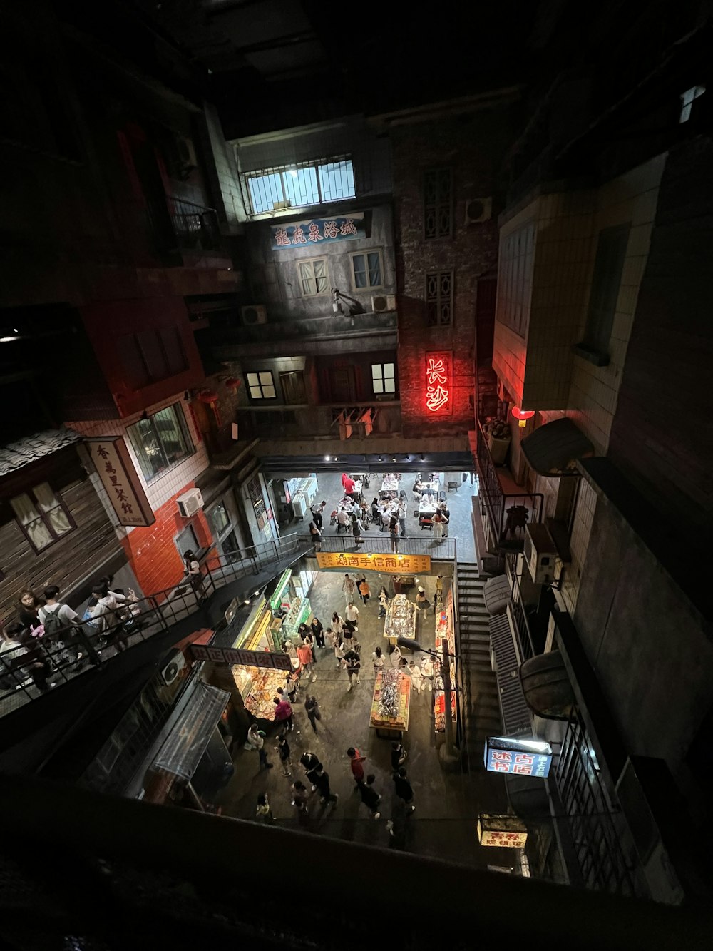 a group of people walking around a building at night