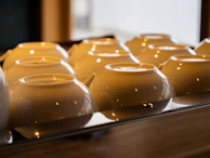 Soft ambient lighting highlighting a countertop with elegant ceramic containers and cutting boards.