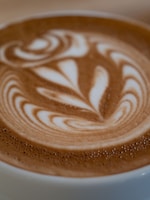 A close-up of a vibrant latte art with floral decorations.