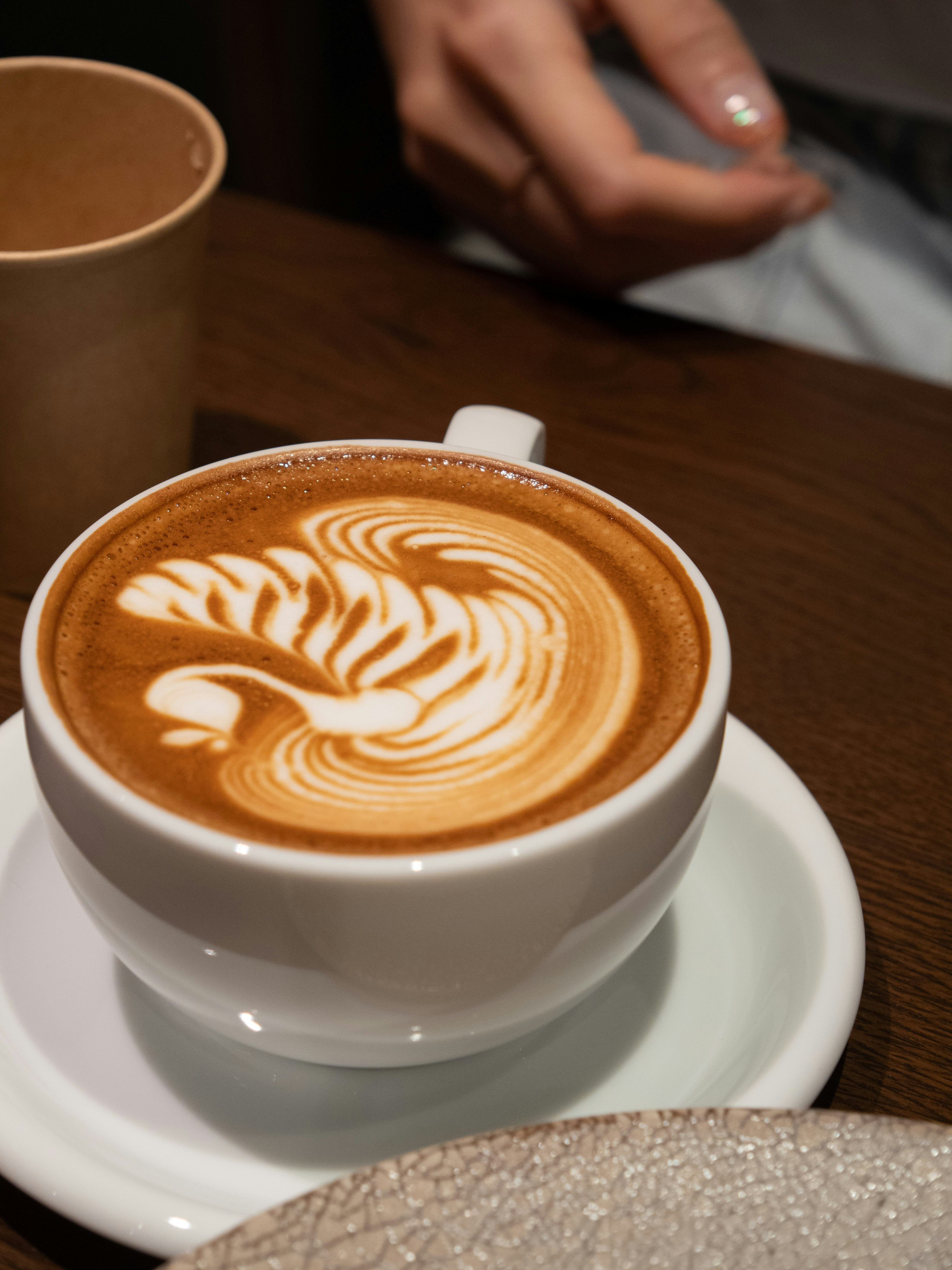 a cappuccino on a saucer on a table
