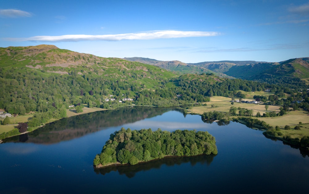 an aerial view of a lake surrounded by mountains