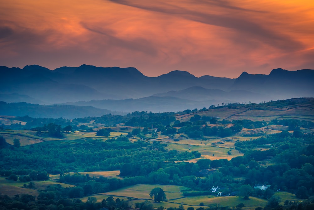 a view of a valley with mountains in the background