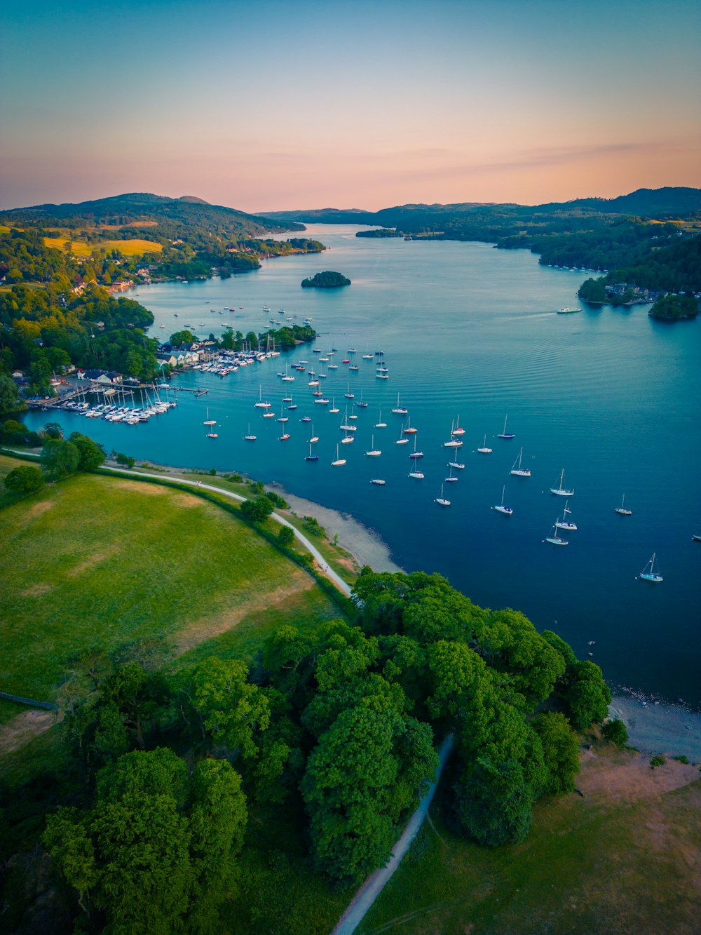 an aerial view of a lake with boats in it