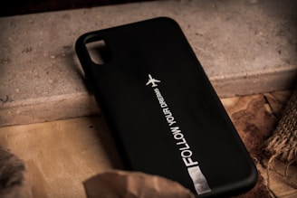 A sleek phone case adorned with an inspiring saying and artistic design elements.