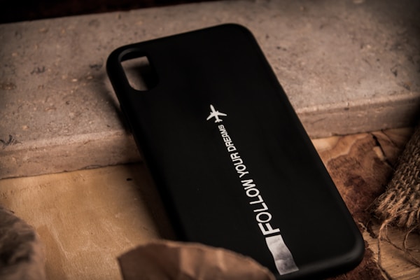 A sleek phone case adorned with an inspiring saying and artistic design elements.