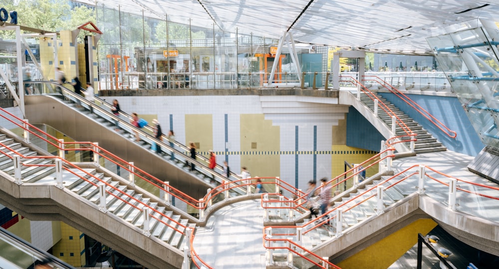 a group of people walking up and down an escalator