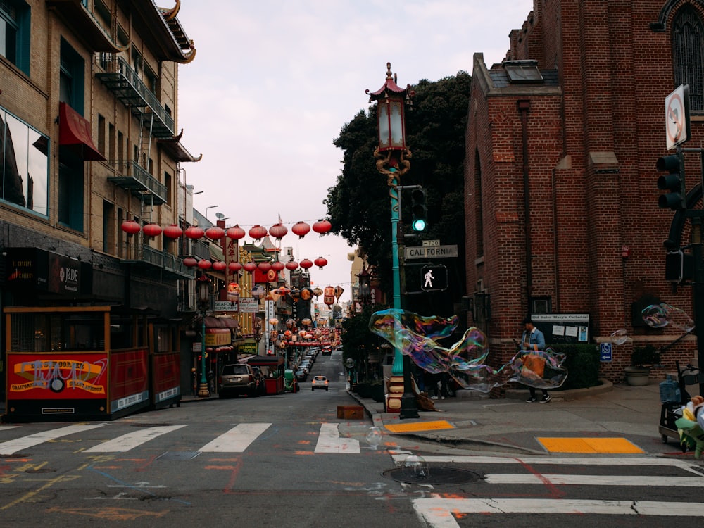 a street with a lot of red lanterns hanging from it's sides