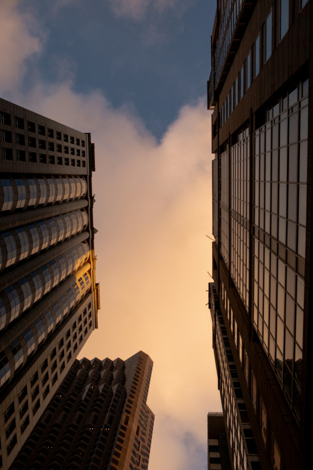 a couple of tall buildings with a sky in the background