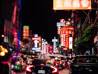 A bustling city street scene from the future, with autonomous vehicles and neon signs in unfamiliar languages.