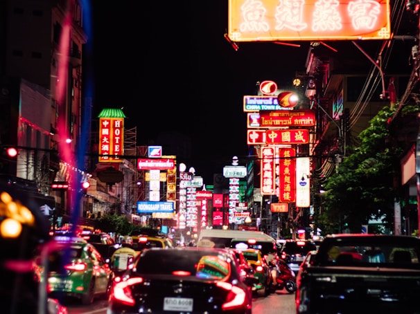 A bustling city street scene from the future, with autonomous vehicles and neon signs in unfamiliar languages.
