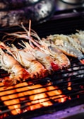 A close-up of sizzling hibachi-style shrimp being grilled.
