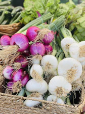 Close-up of vibrant red onions freshly harvested, stacked neatly in crates at Vikram Exports farm.