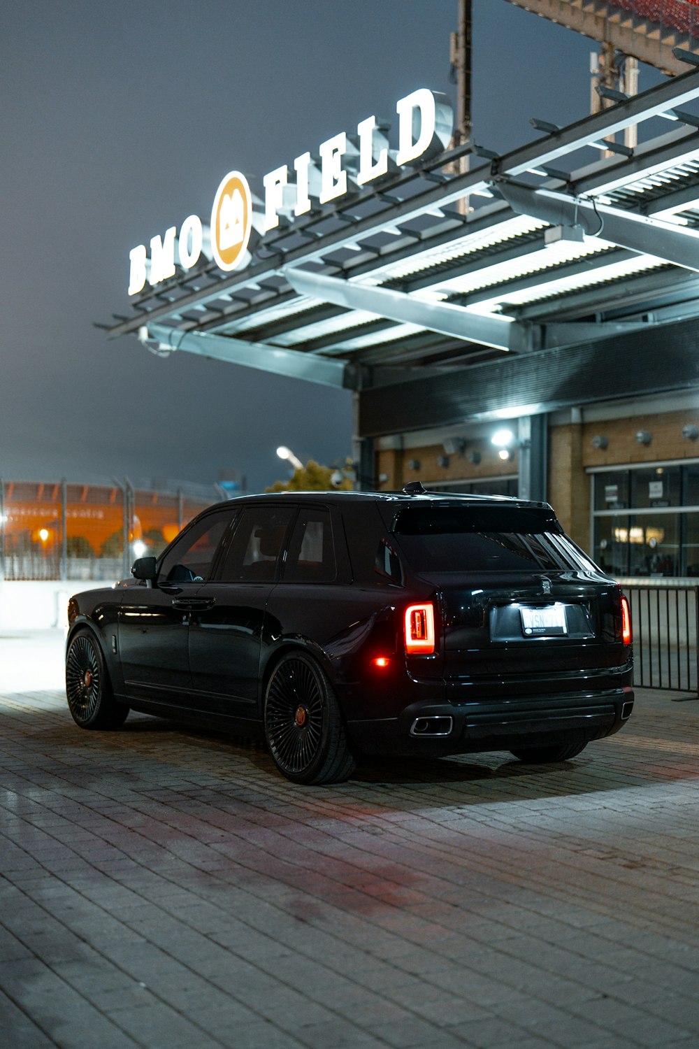 a black suv parked in front of a building