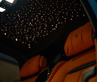 the interior of a car with a star ceiling
