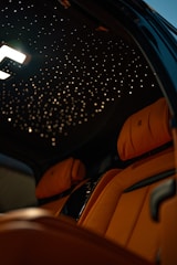 the interior of a car with a star ceiling