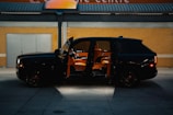 a black suv parked in front of a building
