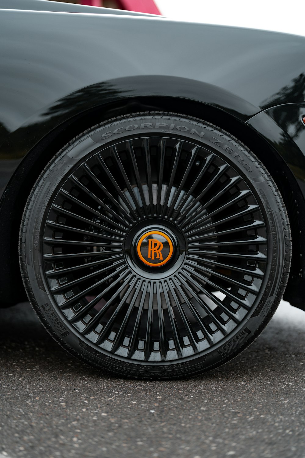 a close up of a black sports car tire