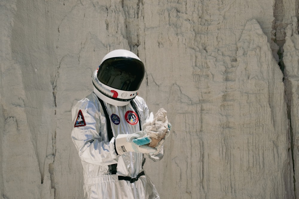 a man in a space suit holding something in his hands
